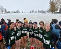 MCC's women's cross country team pictured outside with snow on the ground behind them as they prepare for the NJCAA Division II National Championship meet. 