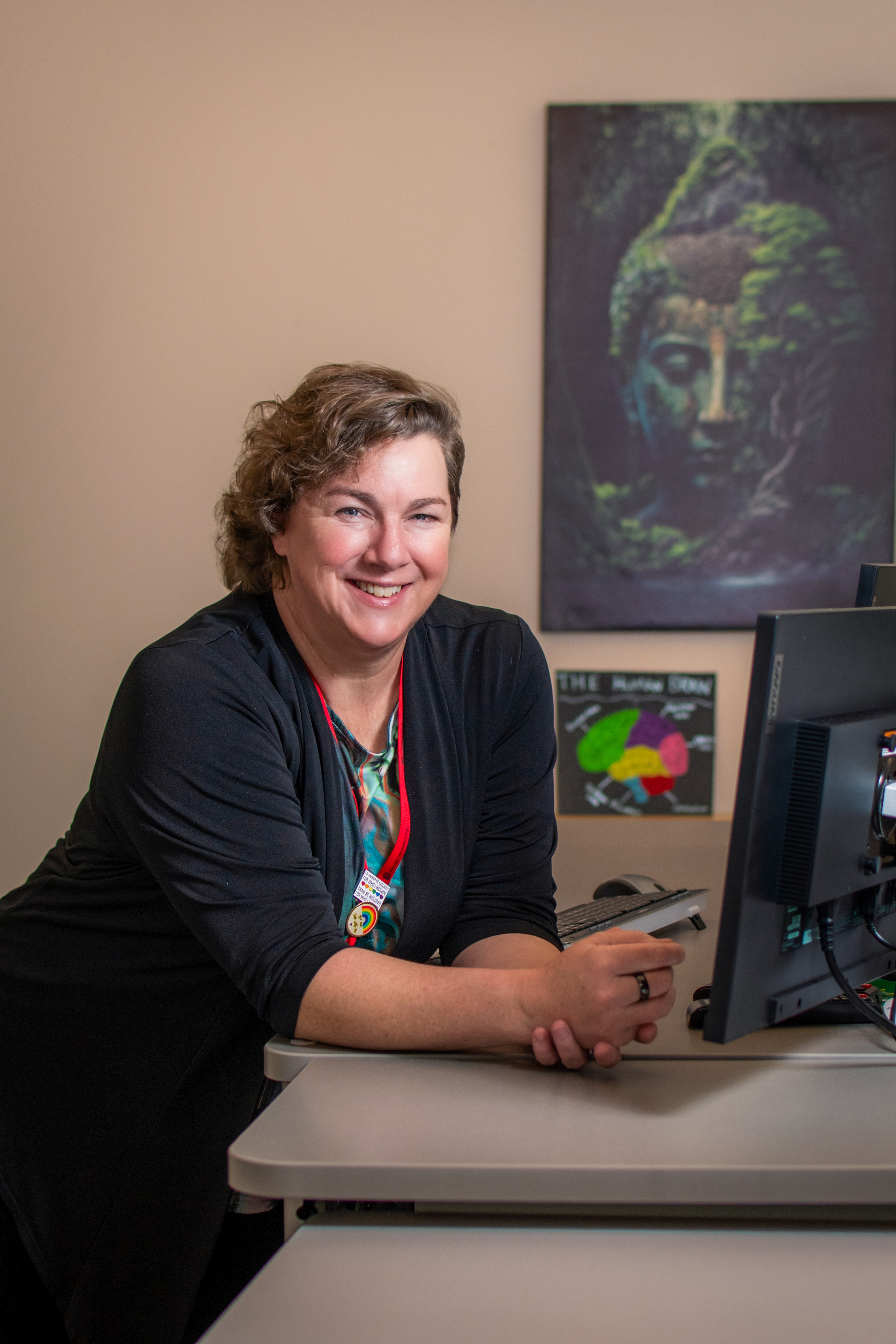 MCC instructor, Jessica Snyder, leaning against a desk and smiling at the camera.