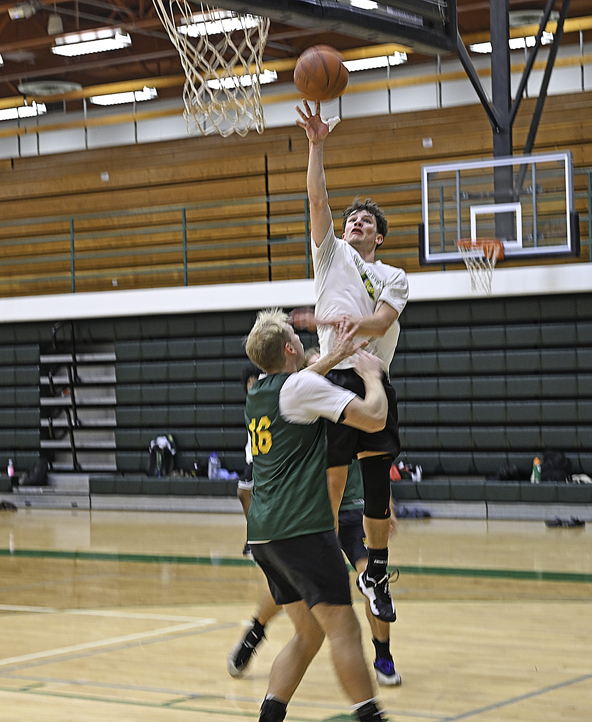 Men's basketball player Trevor Zamarron shooting a layup during practice.